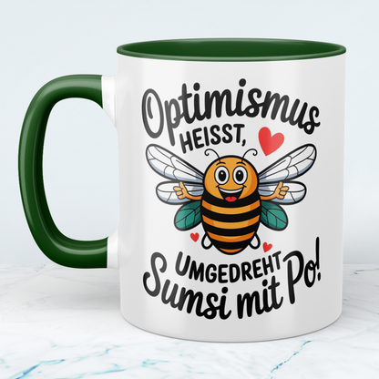 Lustige Tasse mit Spruch: Optimismus heißt umgedreht Sumsi mit Po! - Perfektes Geschenk fürs Büro!